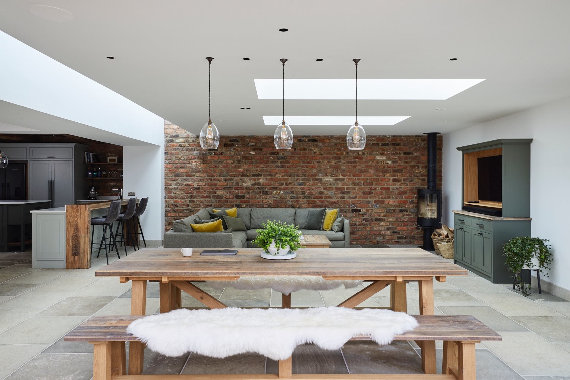 Kitchen/diner/family area with roof lights giving additional natural light.  Two walls tiled with brick slips.