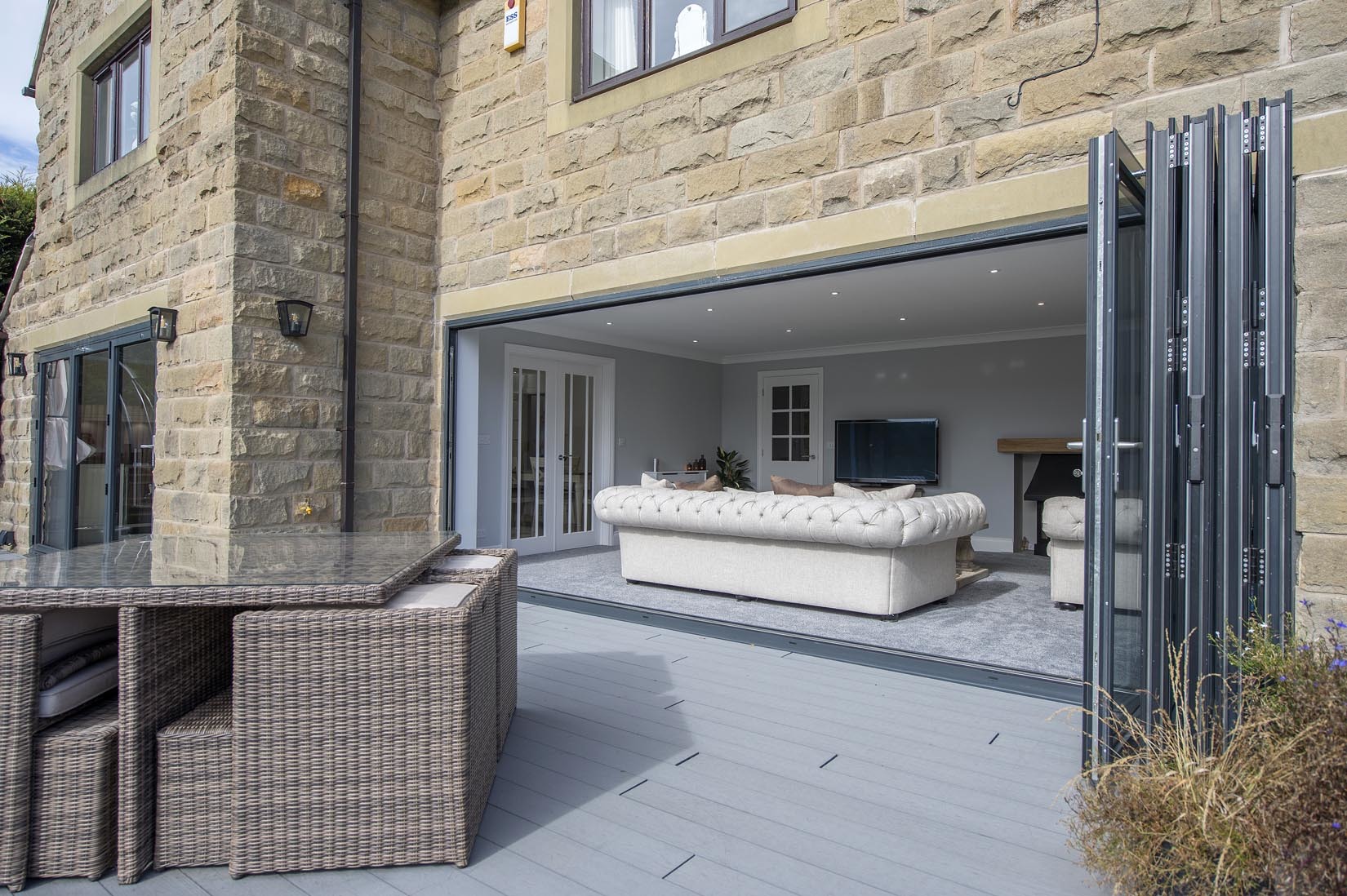 Bi-fold doors lead from the living room on to the refurbished terrace