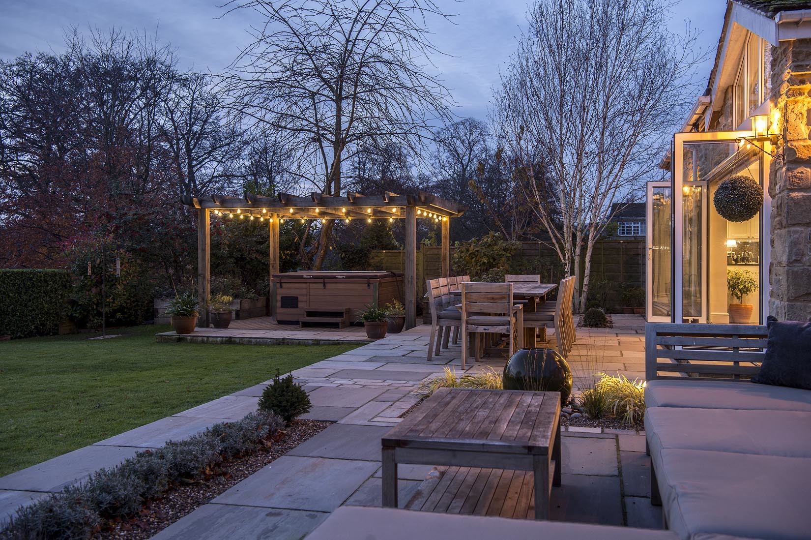 Larger landscaped patio, oak pergola and external lighting